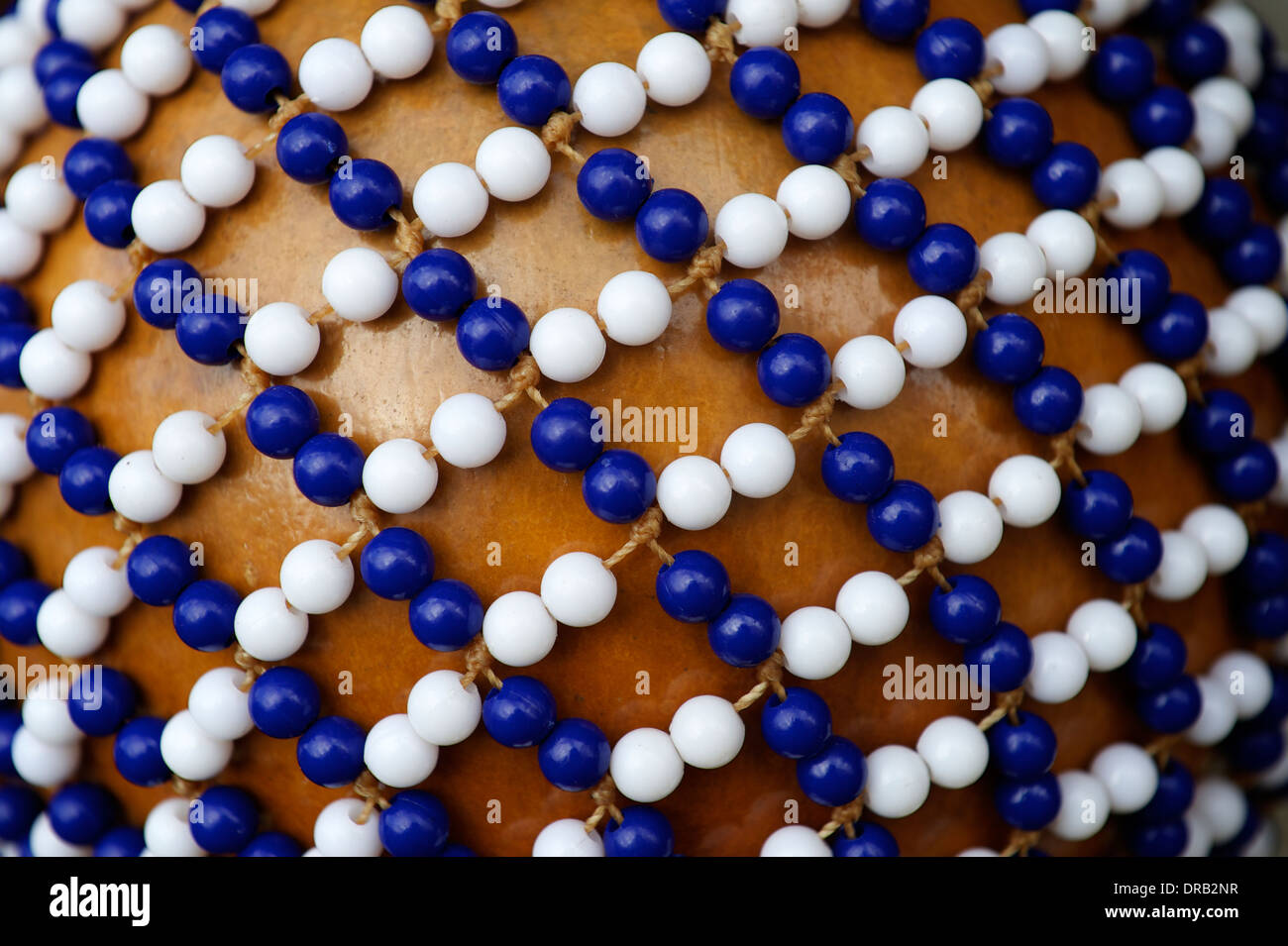 Afro Brazilian music shekere beaded gourd shaker drum close-up with colorful beads Stock Photo