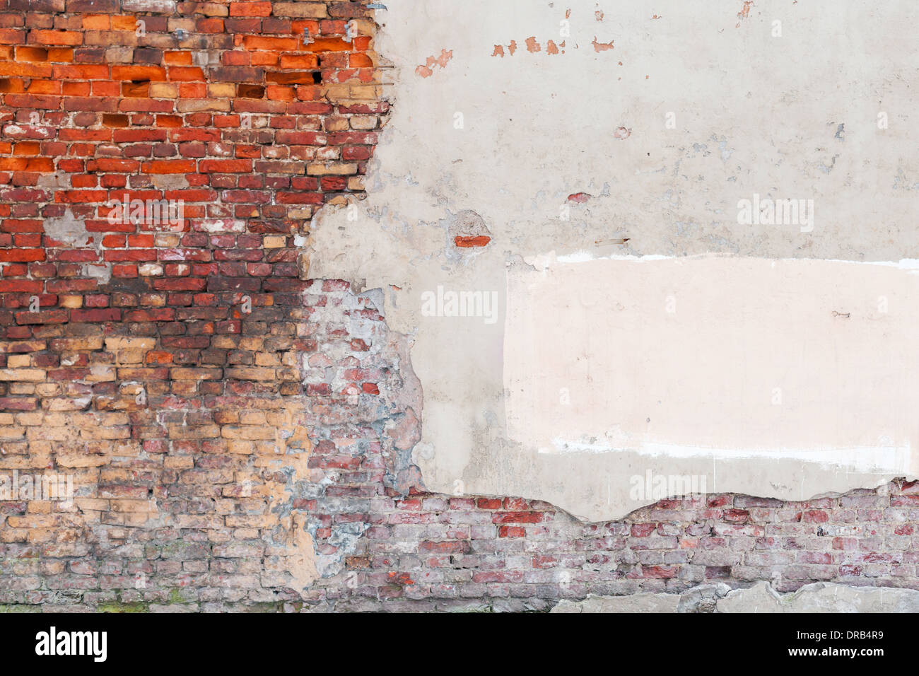 Old grunge wall background texture with bricks and stucco Stock Photo