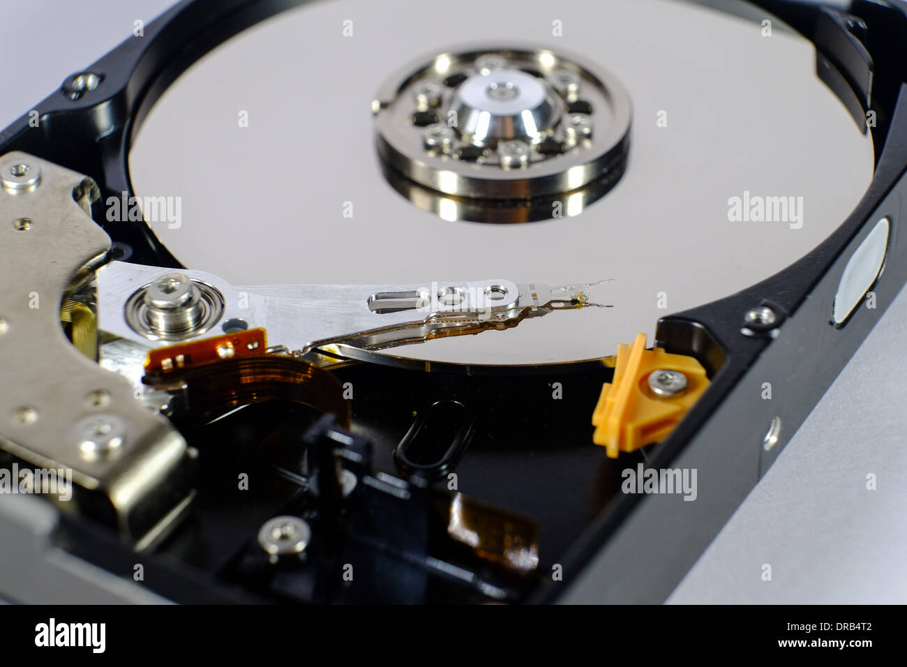 opened hard disk drive shows the disc and the read and write head. focus on the read and write head Stock Photo