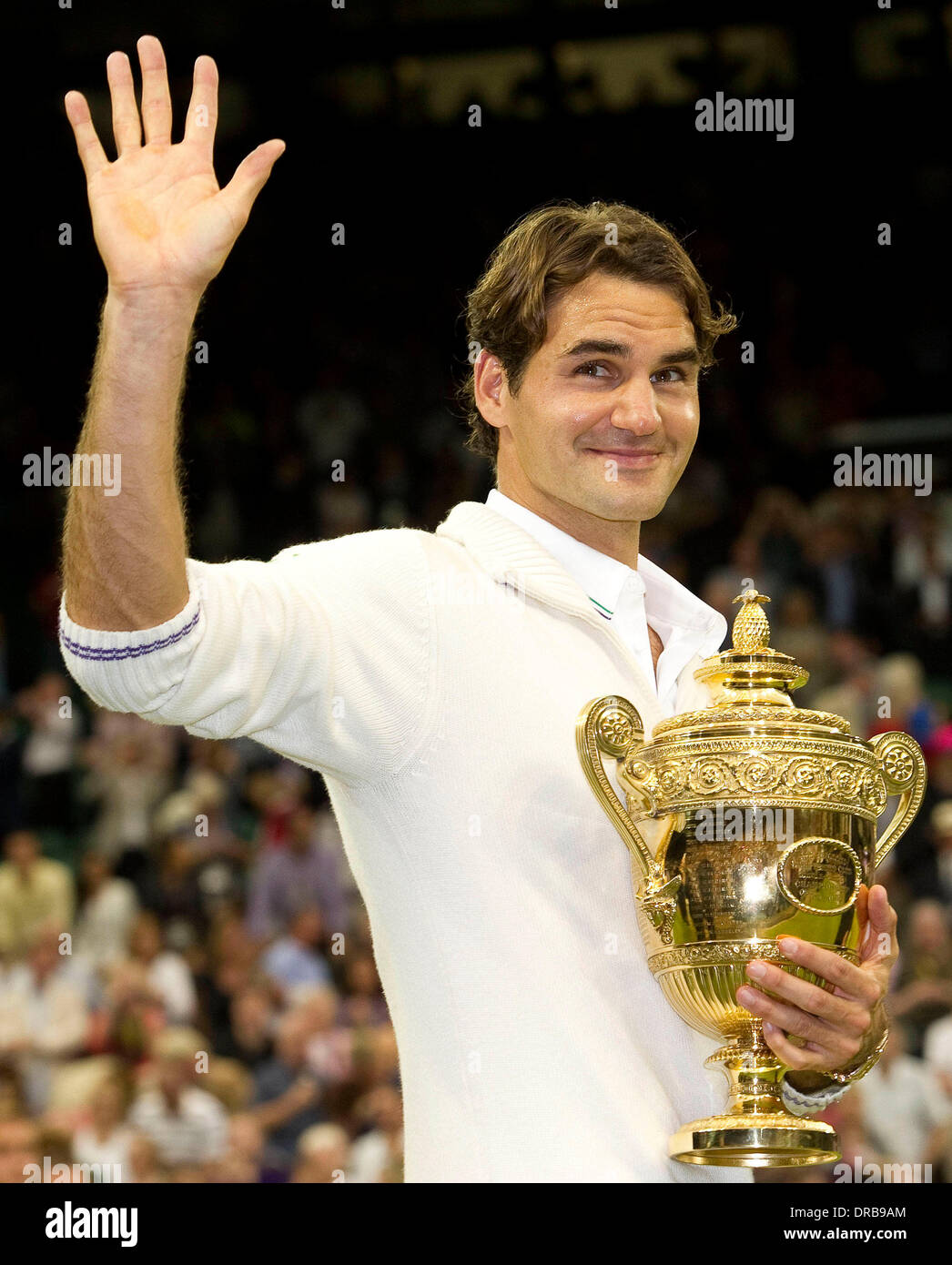 Roger Federer celebrates victory with his trophy after the Wimbledon