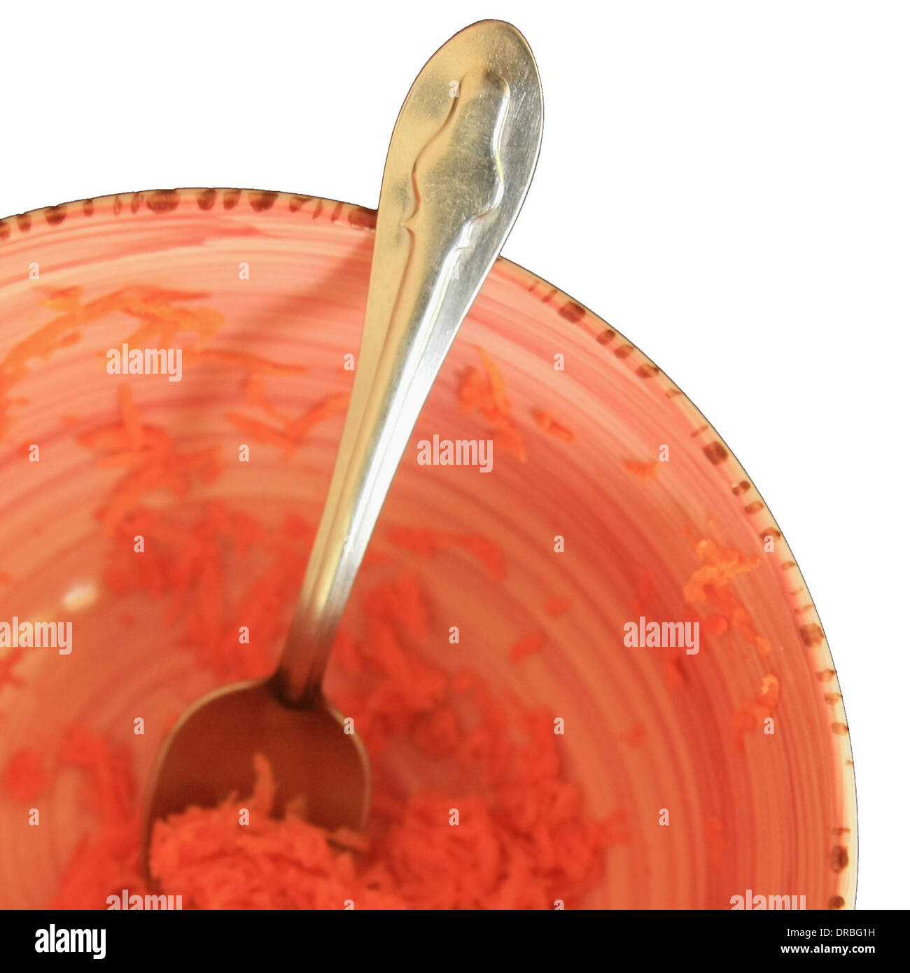 Detail of grated carrots in a bowl isolated on white background Stock Photo