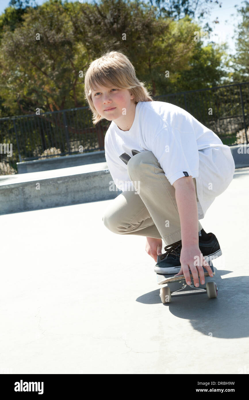 Boy practicing on skateboard Stock Photo