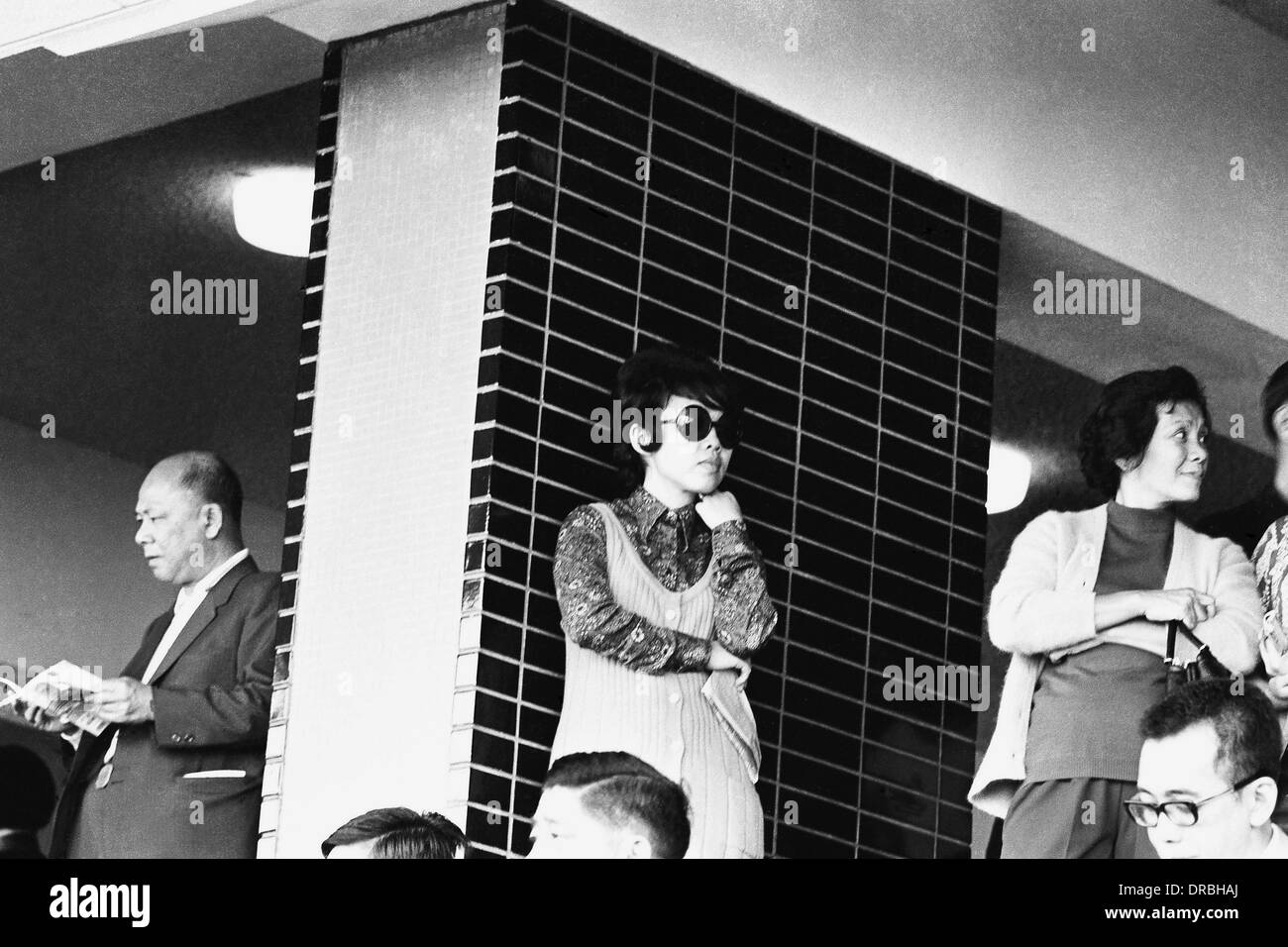 Anxious standing people at race course, Hong Kong, 1971 Stock Photo
