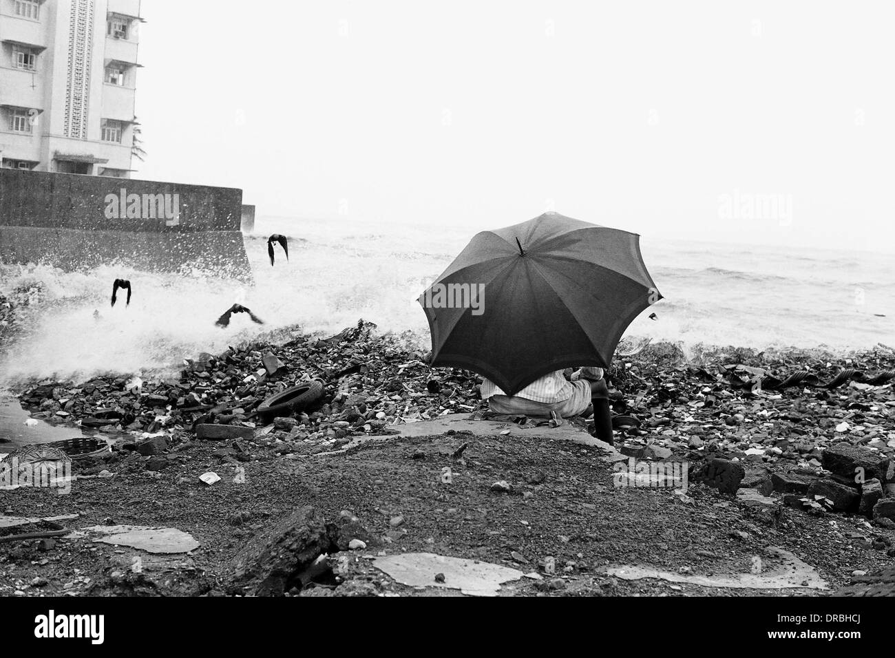 Umbrella, crows and sea waves, Mumbai, Maharashtra, India, 1976 Stock Photo