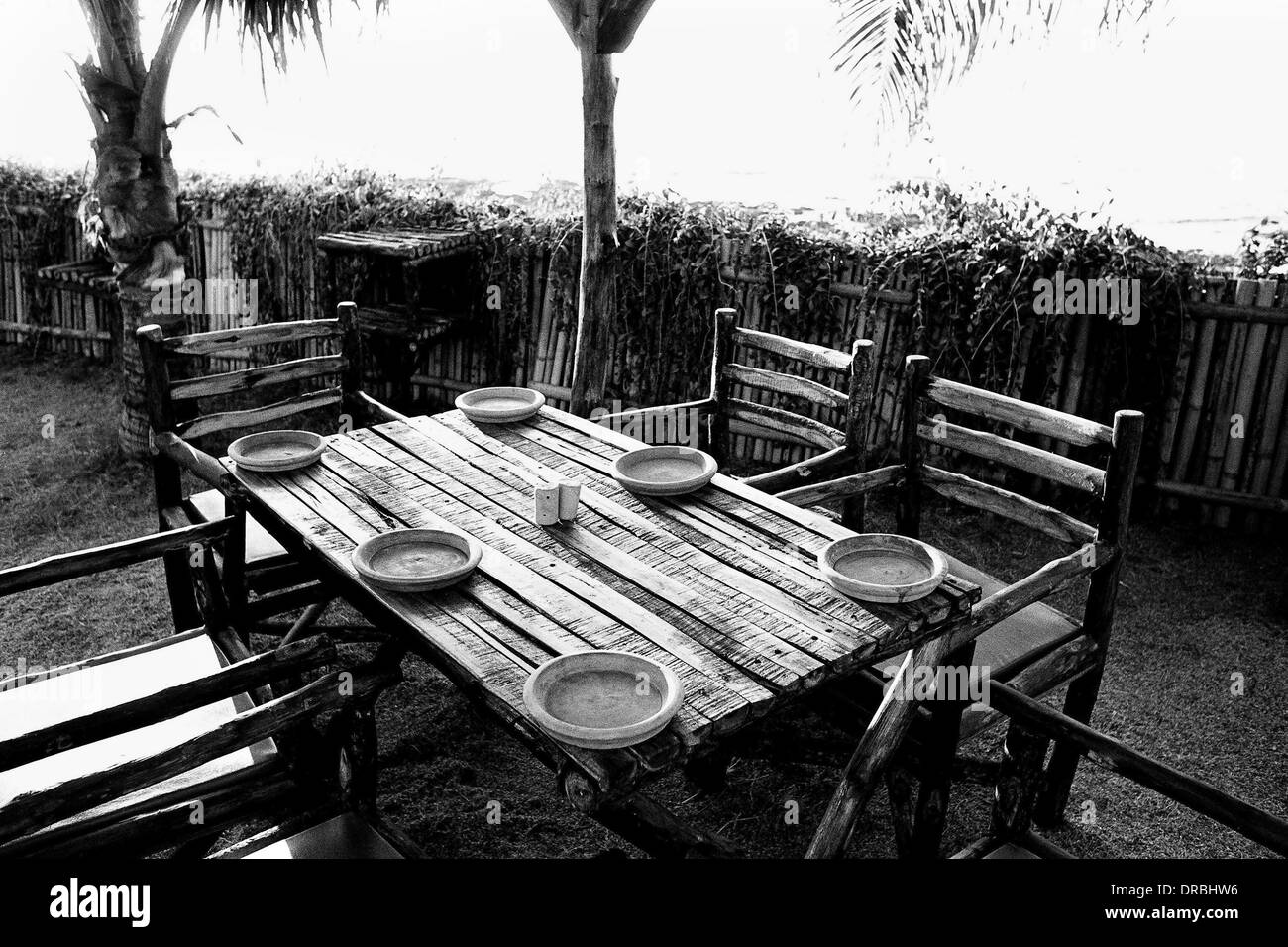 Dining rustic table and chairs for six in restaurant, Mumbai, Maharashtra, India, 1982 Stock Photo