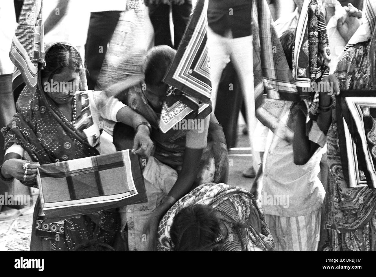 Women buying scarf Vautha fair Gujarat India Asia 1983 Stock Photo