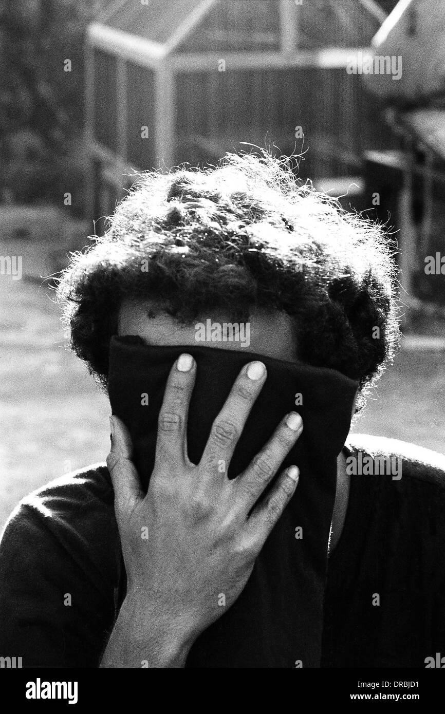 Drug addict expressing shame, Mumbai, Maharashtra, India, 1986 Stock Photo