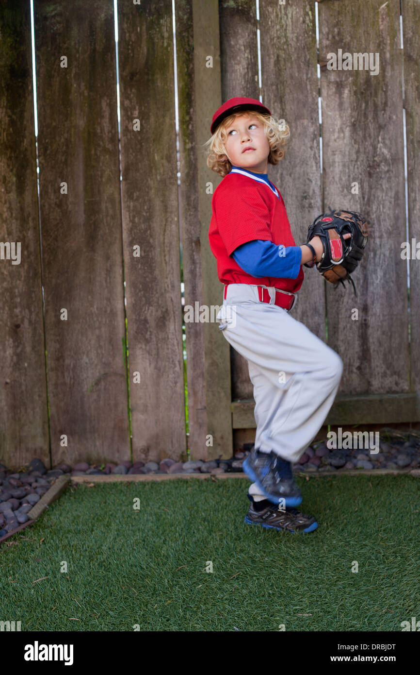 Boy throwing a baseball in the backyard Stock Photo Alamy