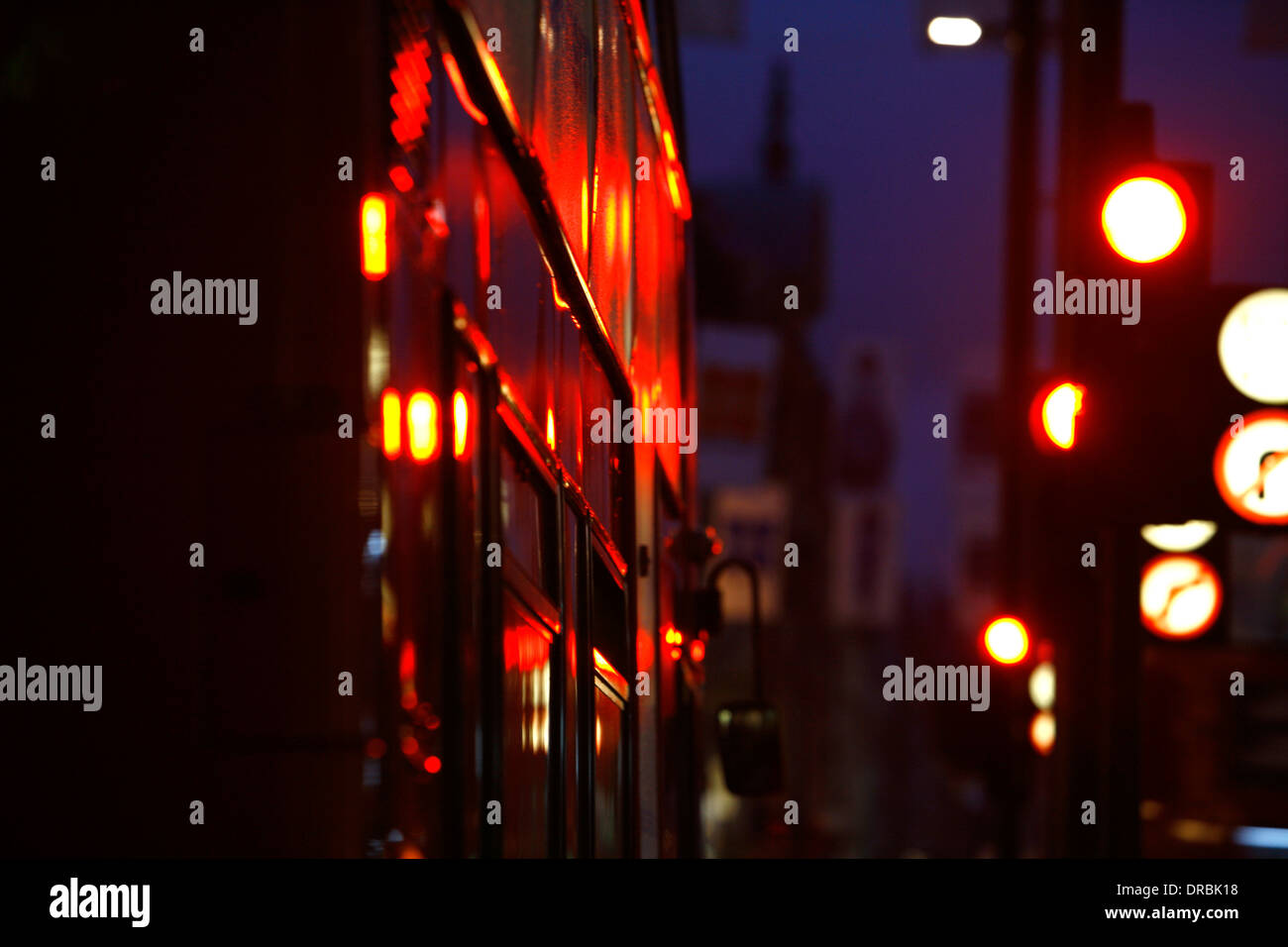 Traffic lights reflecting off the side of a double decker bus on Oxford Street, London, UK Stock Photo