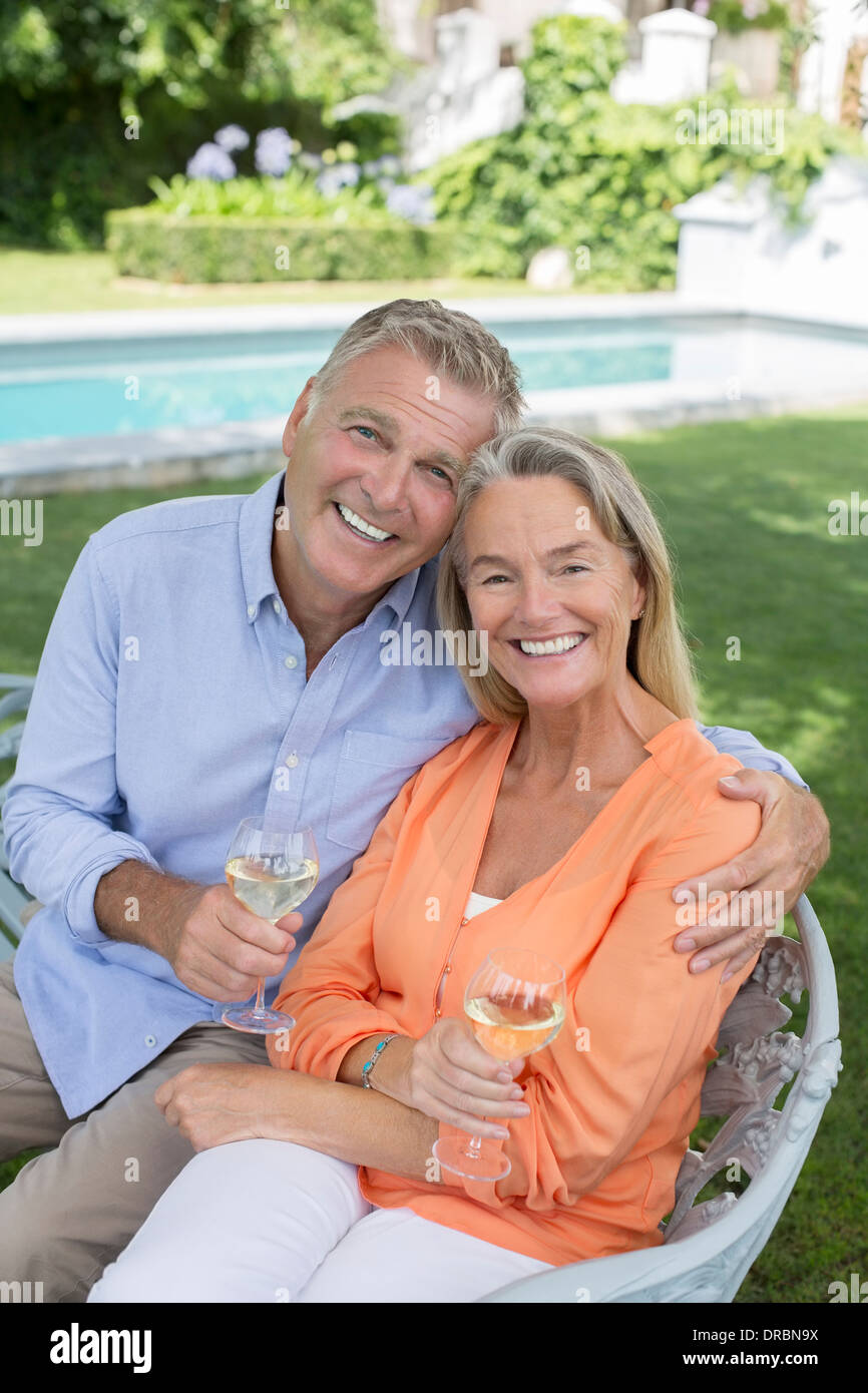 Senior couple drinking wine in backyard Stock Photo