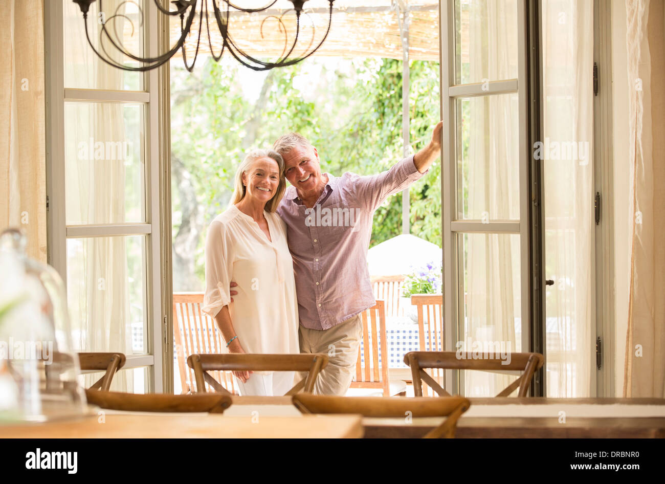 Couple smiling in doorway Stock Photo