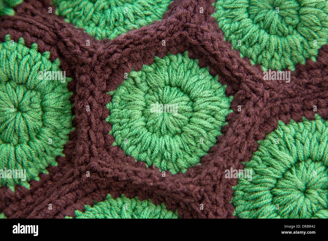Close-up view of crochet stitch in green and brown yarn. Stock Photo