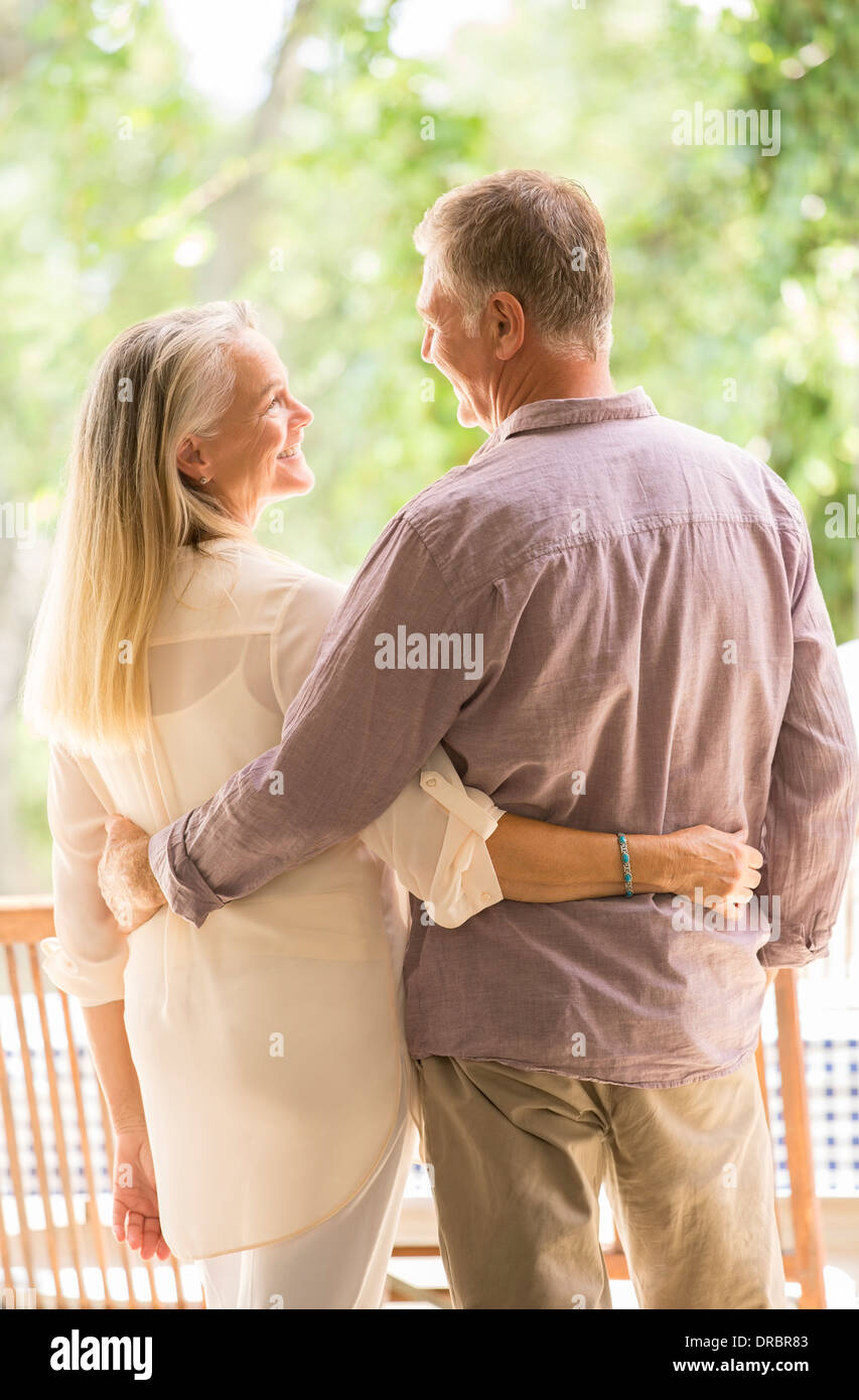 Senior couple hugging on patio Stock Photo