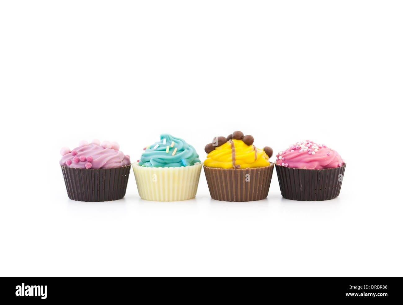 Assorted multicolored cupcakes in a row Stock Photo