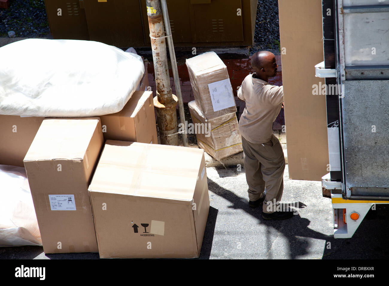 Workers Delivering Packed Furniture in Boxes to Address in cape Town South Africa Stock Photo