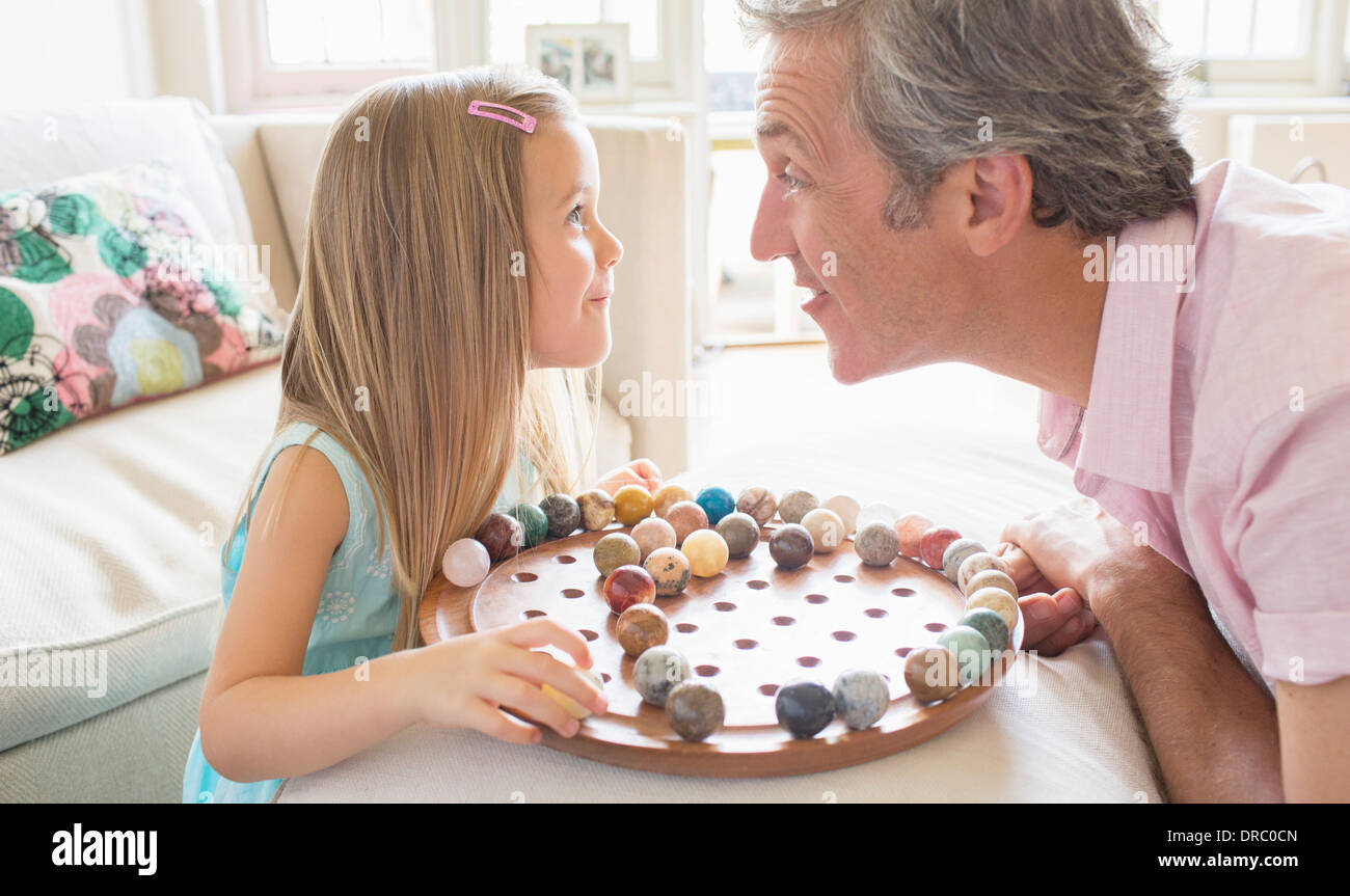 Father and daughter playing Chinese checkers Stock Photo