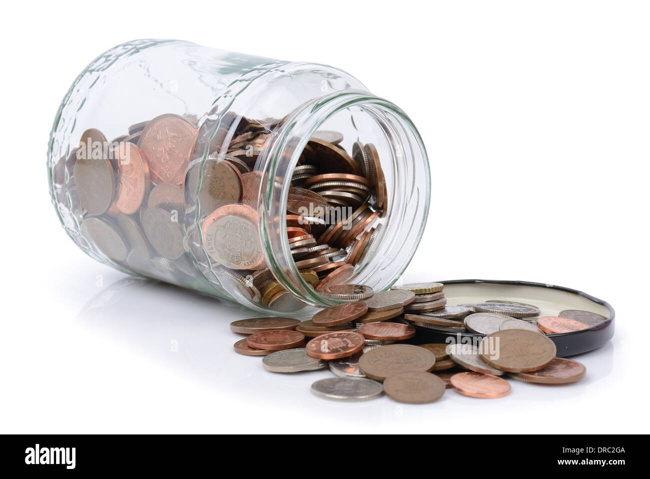 using the rainy day fund, coins spilling out of a jar Stock Photo