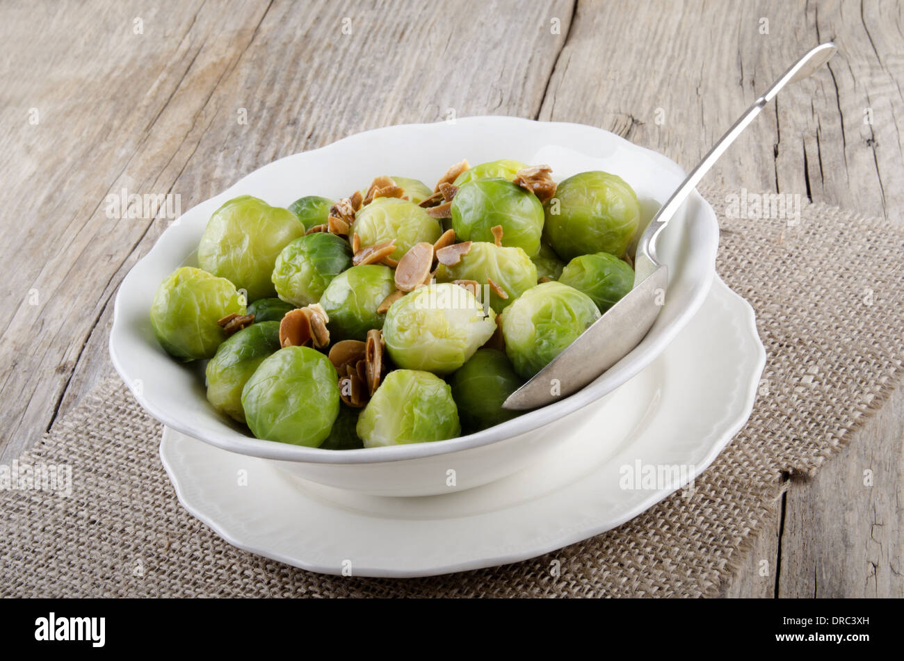 brussel sprouts with roasted almonds in a white bowl Stock Photo
