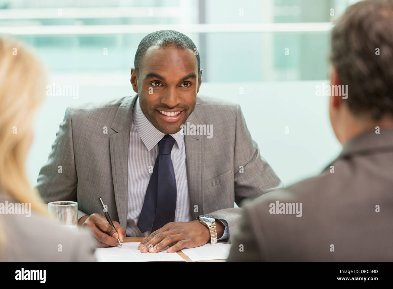 Businessman taking notes in meeting Stock Photo