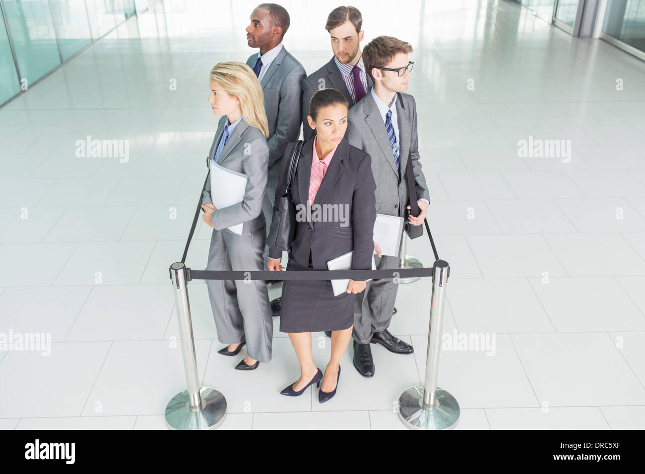 Business people standing in roped-off square Stock Photo