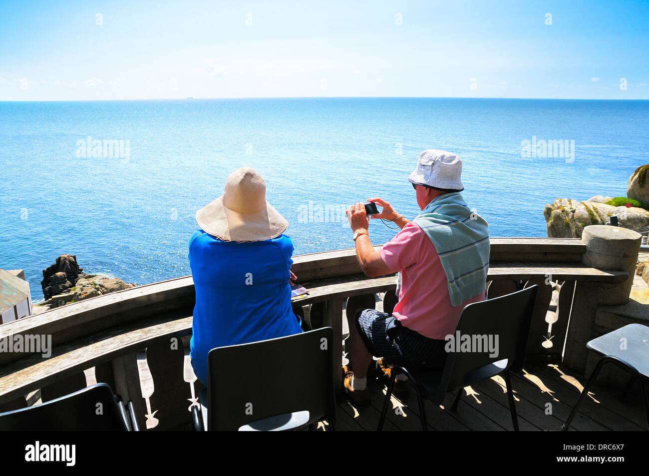 Senior couple relaxing with sea view in summer sun Stock Photo