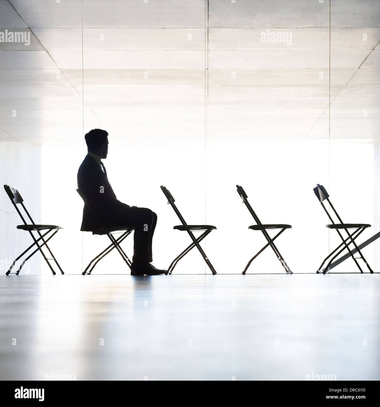 Silhouette of businessman sitting in office Stock Photo