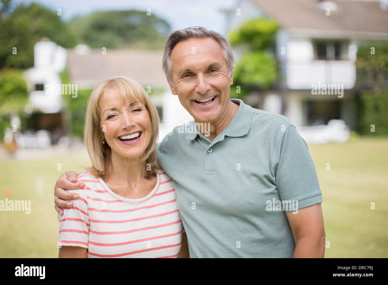Smiling senior couple hugging outdoors Stock Photo