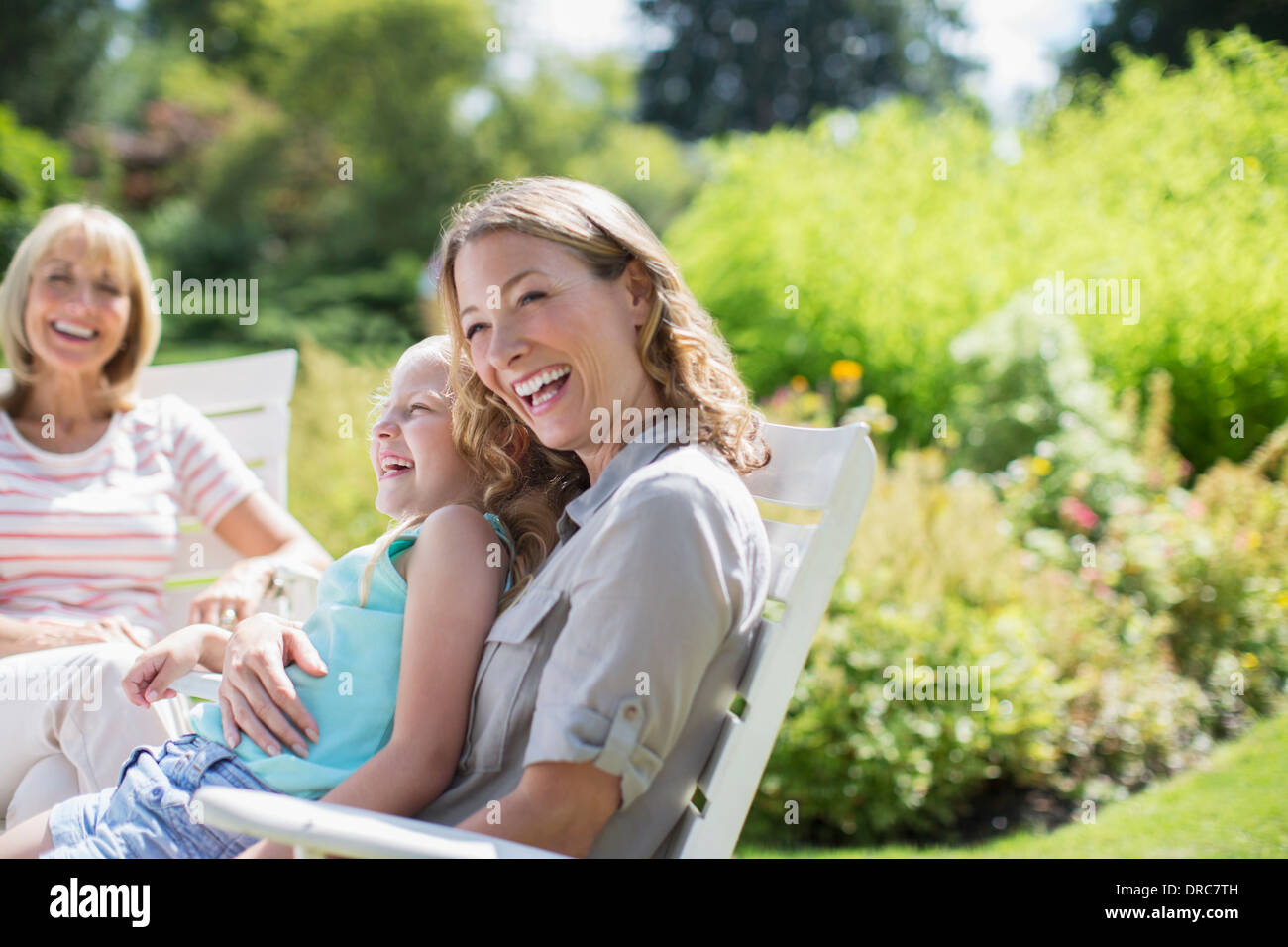 Multi-generation women laughing in backyard Stock Photo