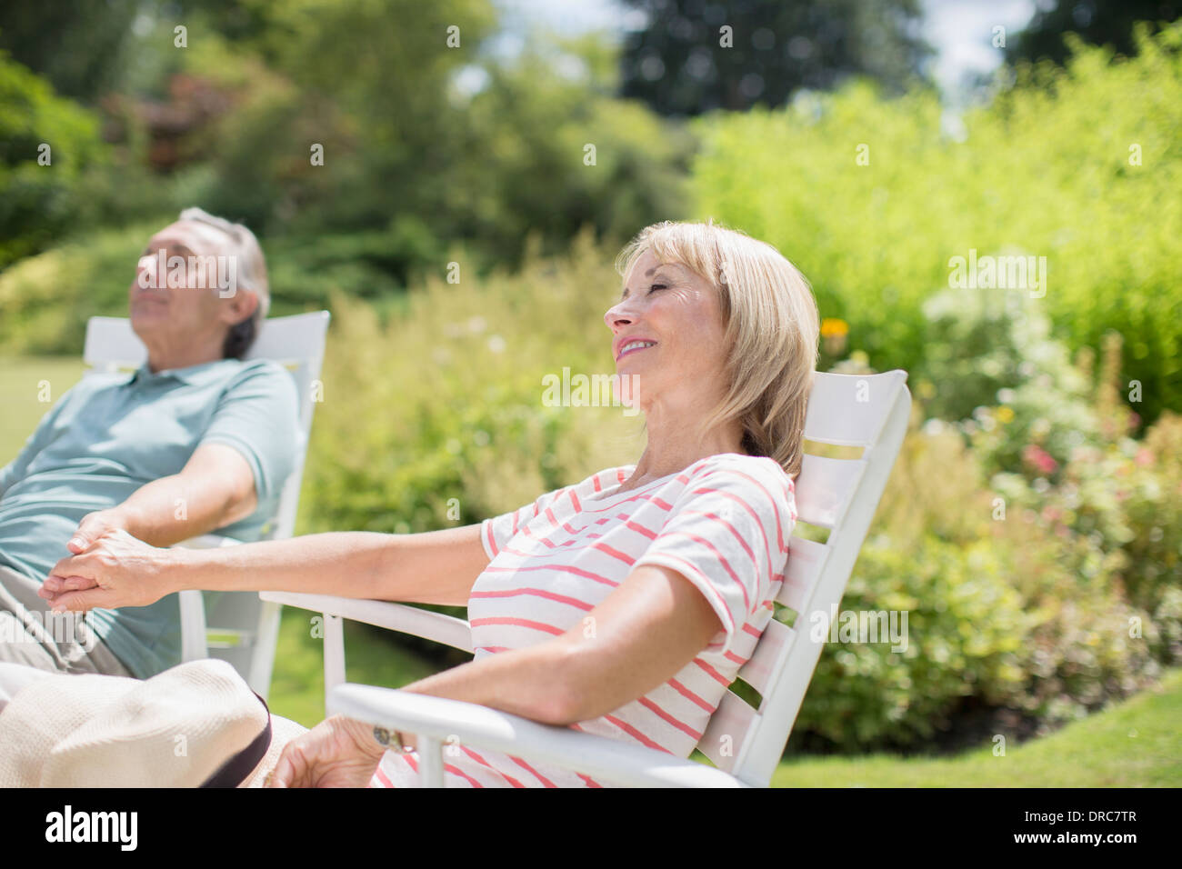 Senior couple relaxing in backyard Stock Photo