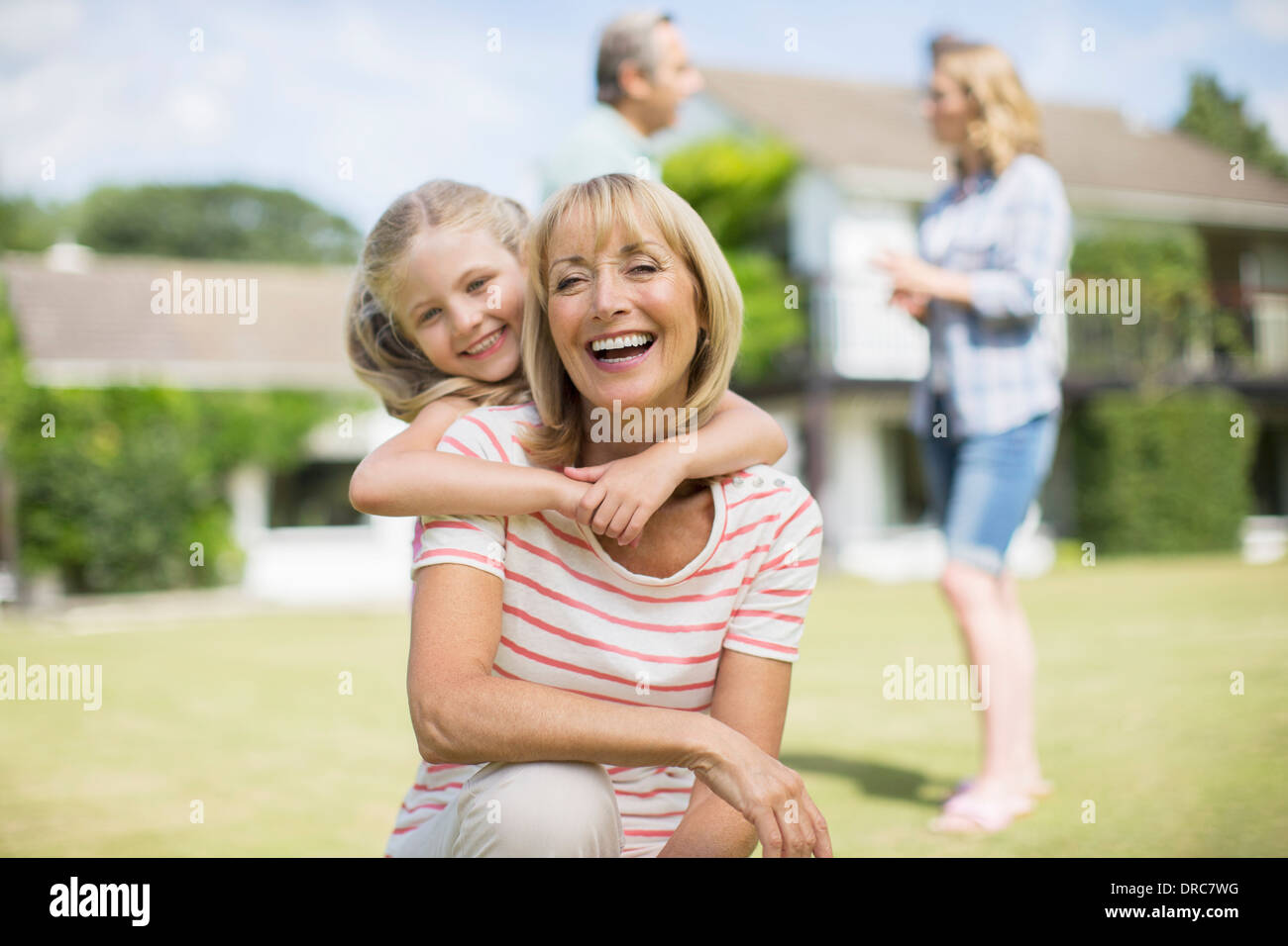 Grandmother and granddaughter hugging outdoors Stock Photo