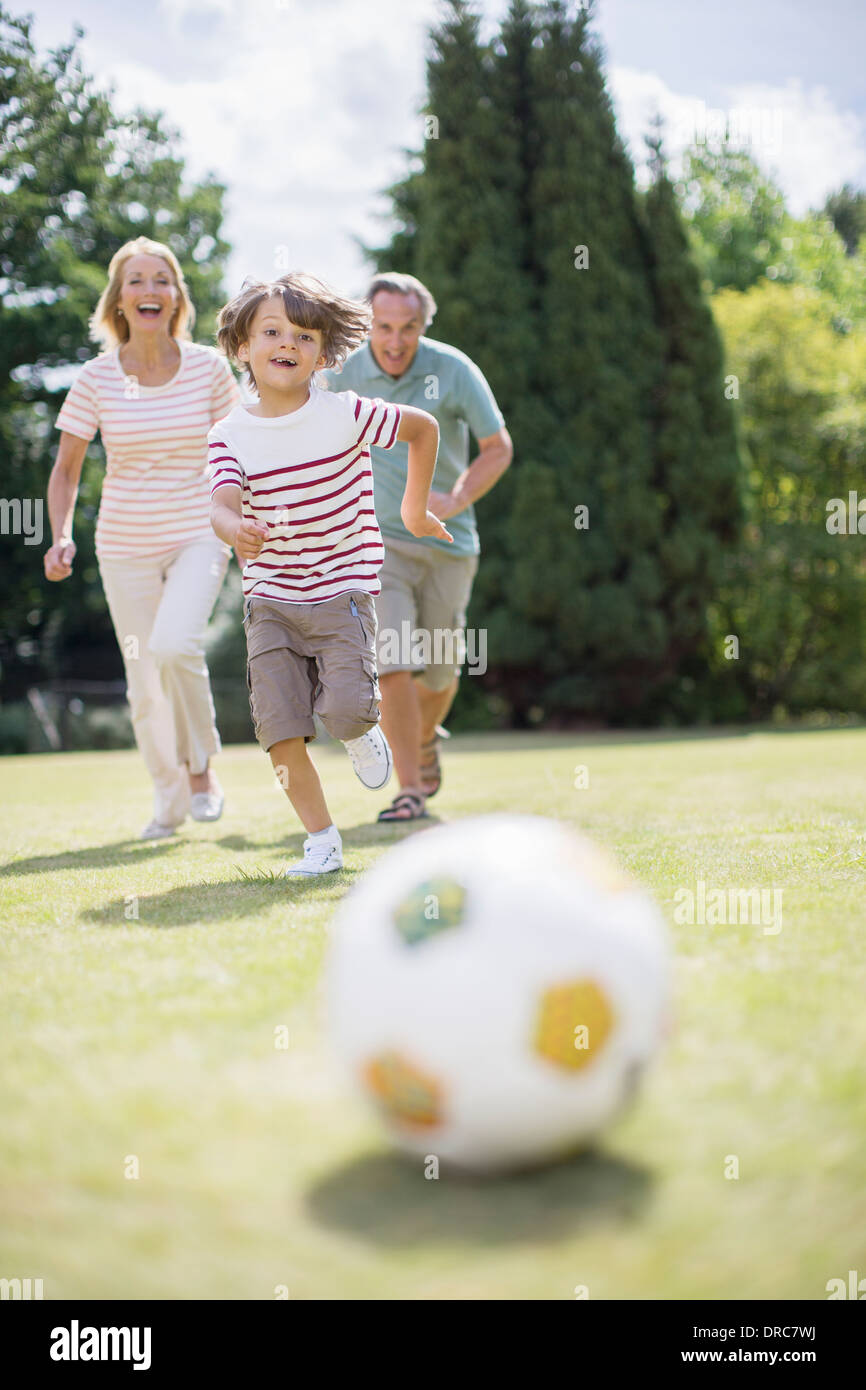 Grandparents and grandson playing soccer Stock Photo