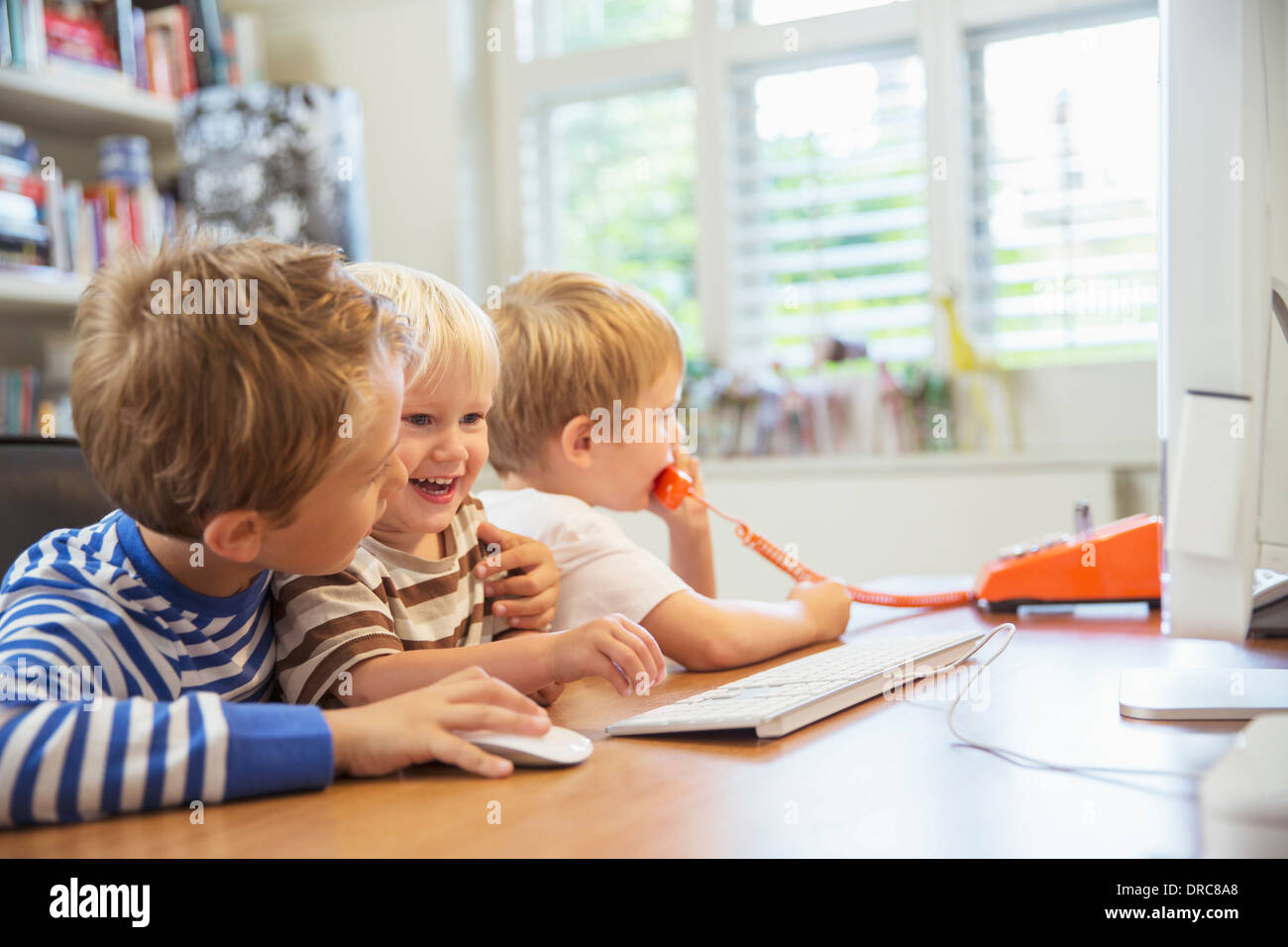 Children using home office together Stock Photo