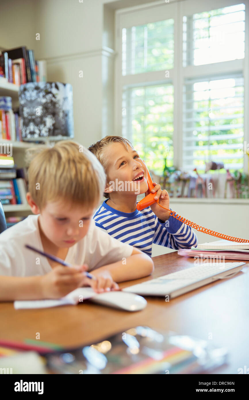 Boys working in home office Stock Photo
