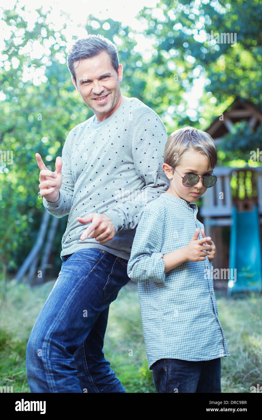 Father and son gesturing outdoors Stock Photo