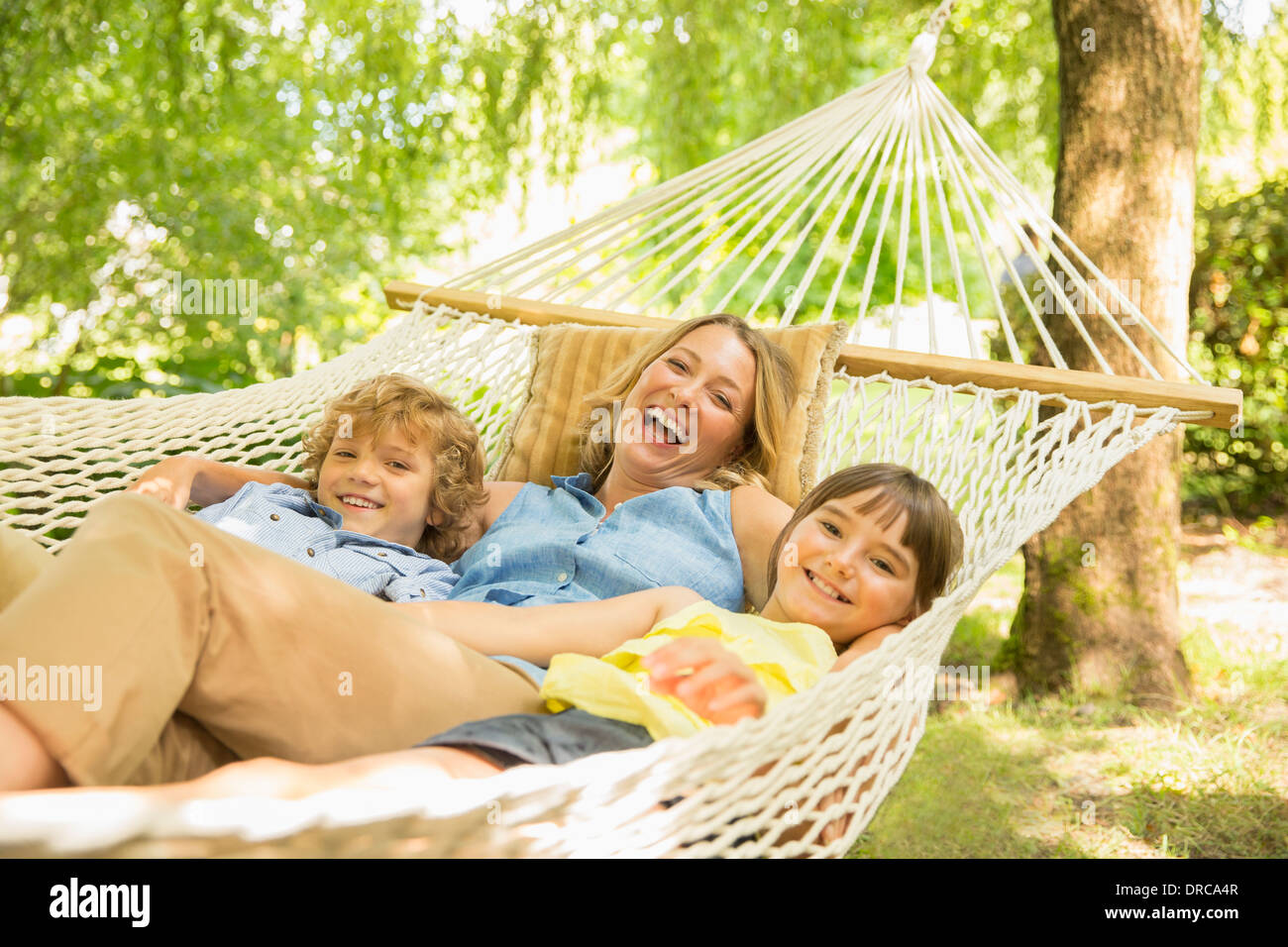 Mother and children relaxing in hammock Stock Photo