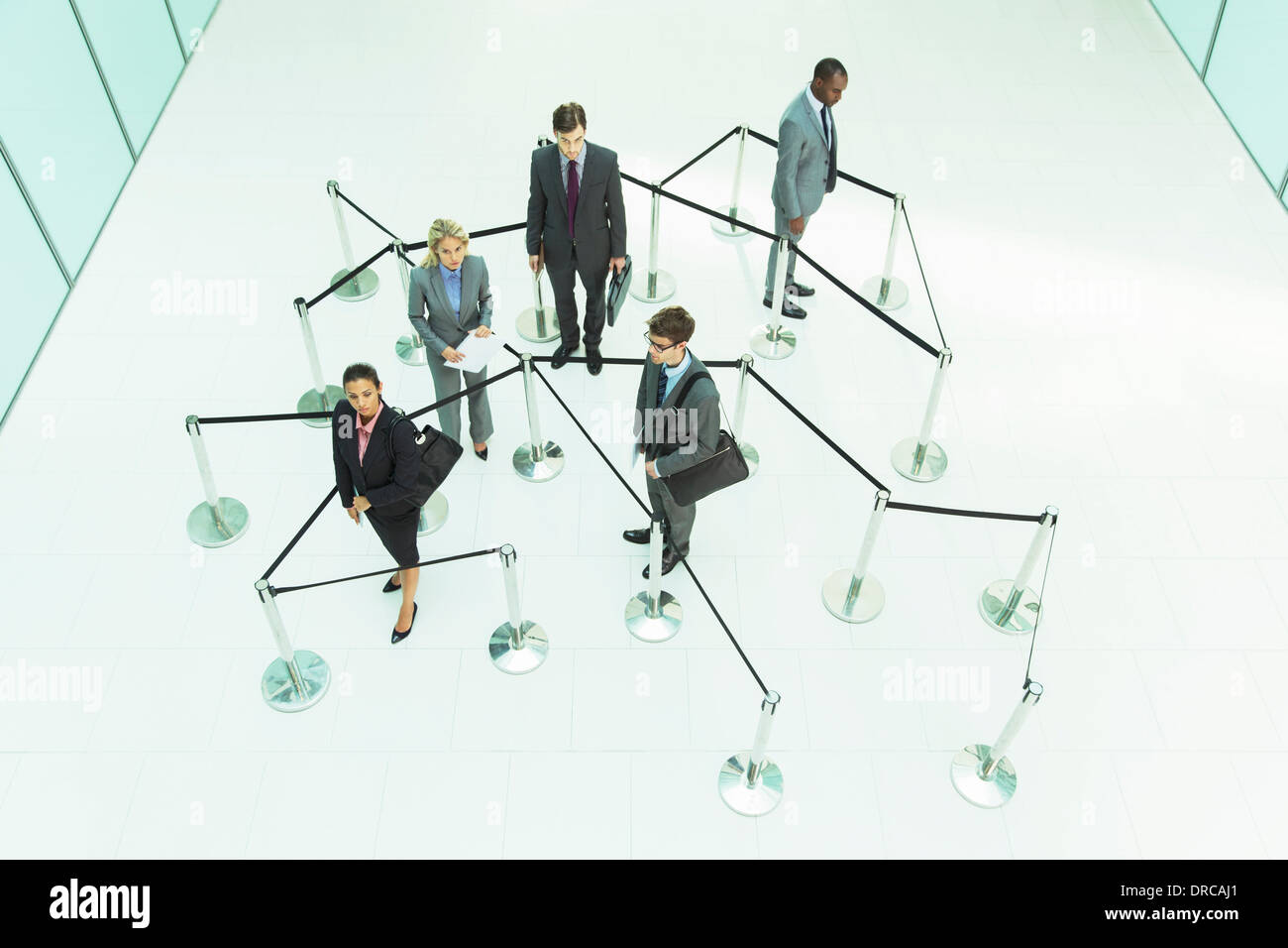 Business people waiting in roped off area Stock Photo - Alamy