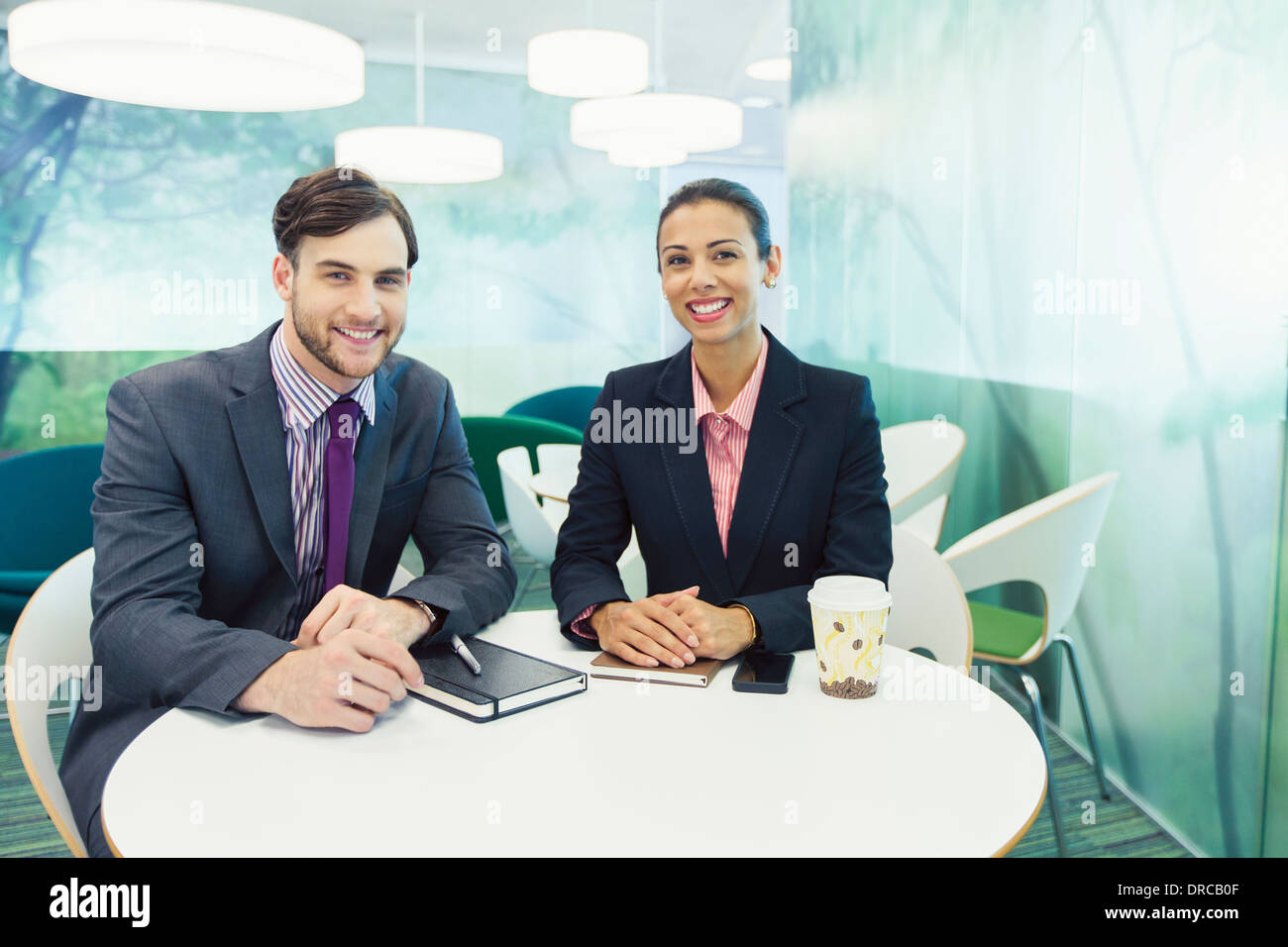 Business people smiling in cafe Stock Photo