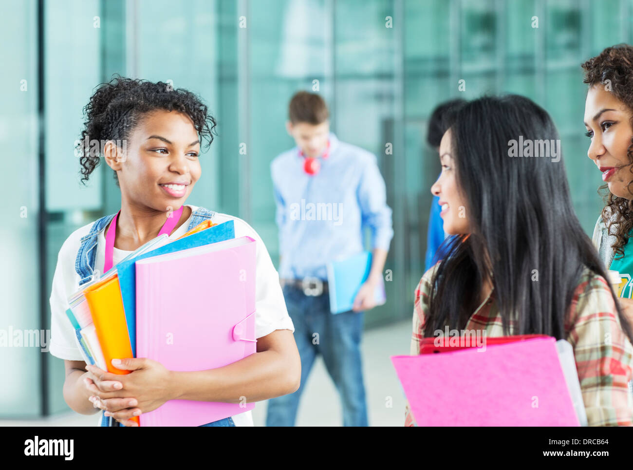 University students talking in corridor Stock Photo