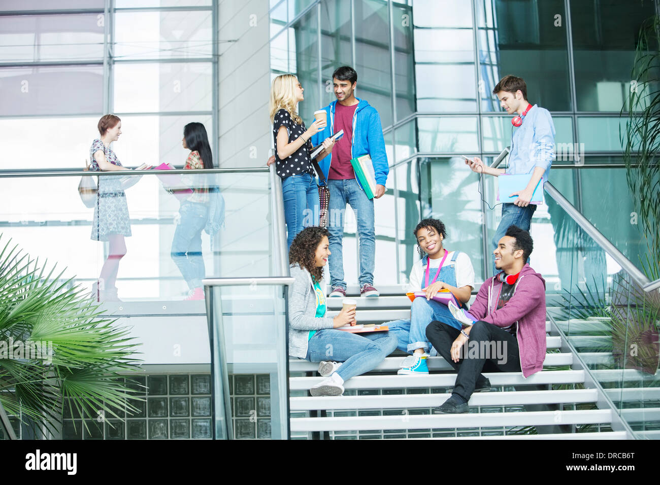 University students relaxing on steps Stock Photo