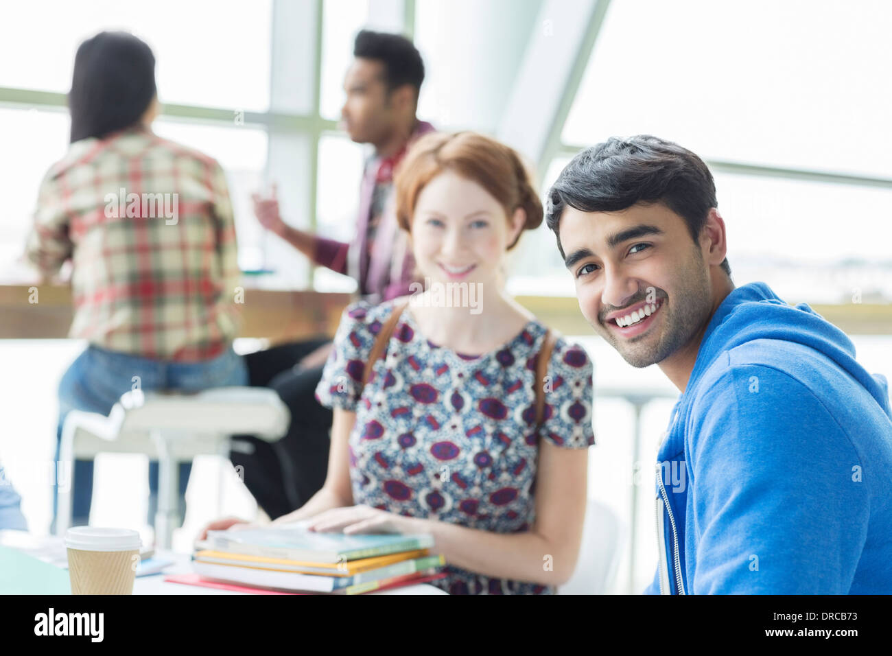 Students smiling in cafe Stock Photo