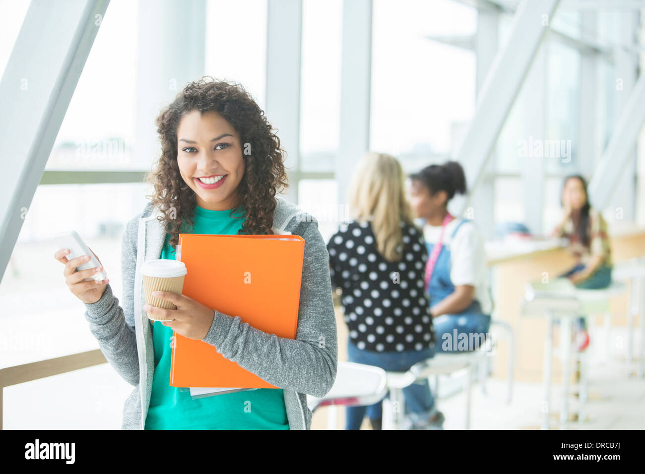 University student smiling in cafe Stock Photo