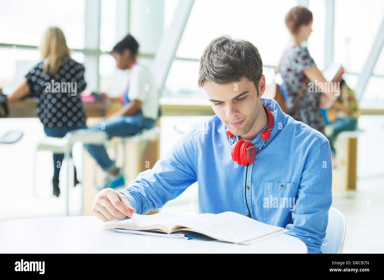 University student reading in cafe Stock Photo