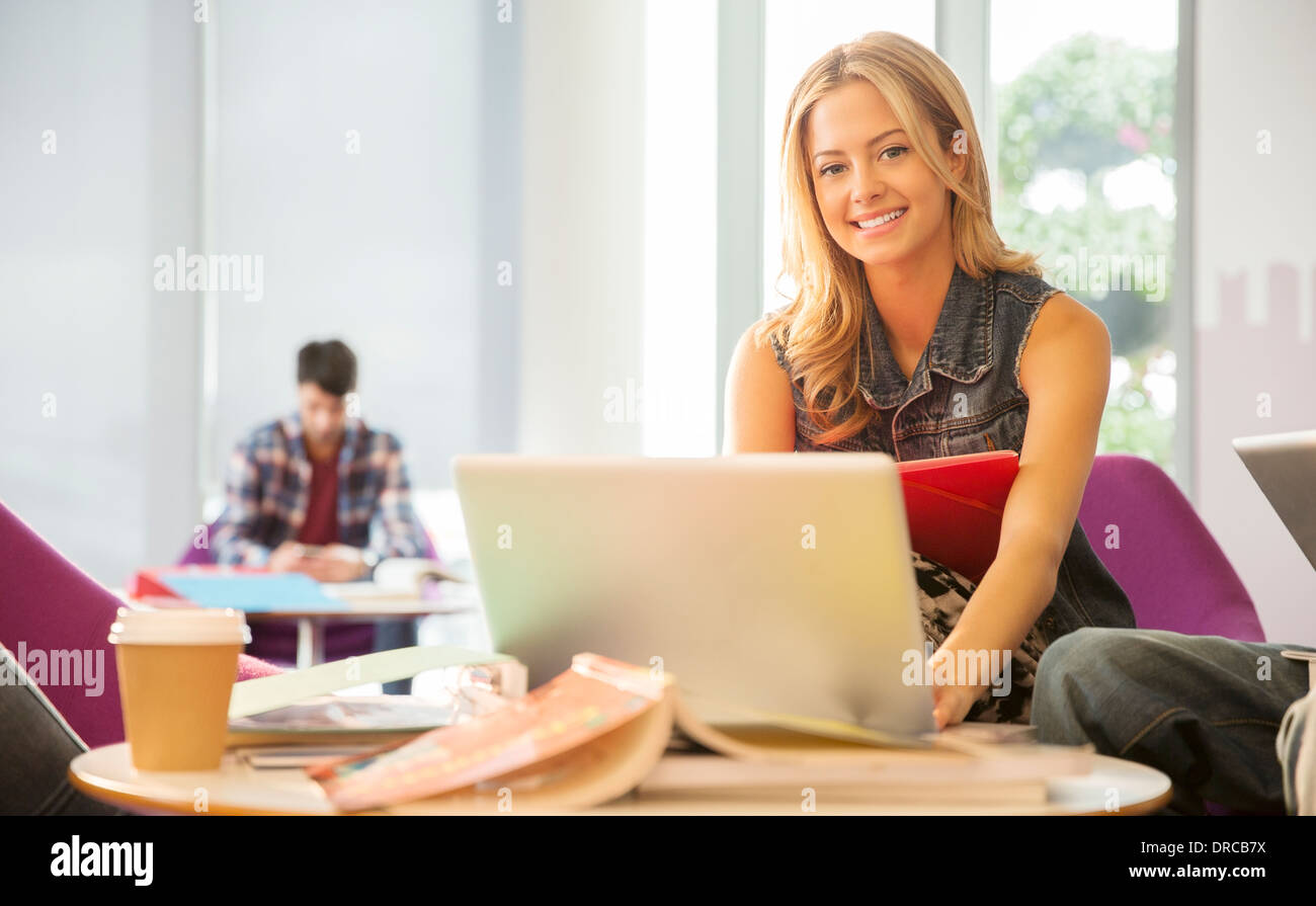 University student using laptop in lounge Stock Photo
