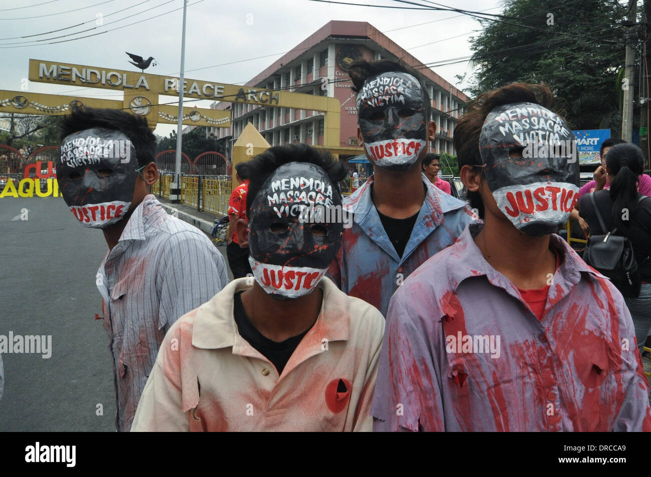 Manila, Philippines. 22nd Jan, 2014. MANILA, Philippines - Performers don masks asking for justice for the Mendiola Massacre victims as farmers led by militant peasant group Kilusang Magbubukid ng Pilipinas (KMP) marched from the Department of Agrarian Reform (DAR) to the historic Mendiola Bridge in Manila, Philippines on 22 January 2014, to call for a broad united front to oust President Benigno Aquino III from his seat. The KMP filed a plunder complaint against President Aquino and a few of his cabinet members for the alleged misuse of the P125 million funds intended for energy related deve Stock Photo