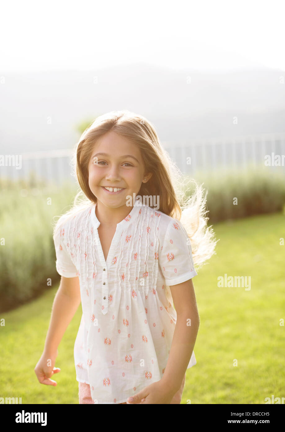 Happy girl running in grass Stock Photo Alamy