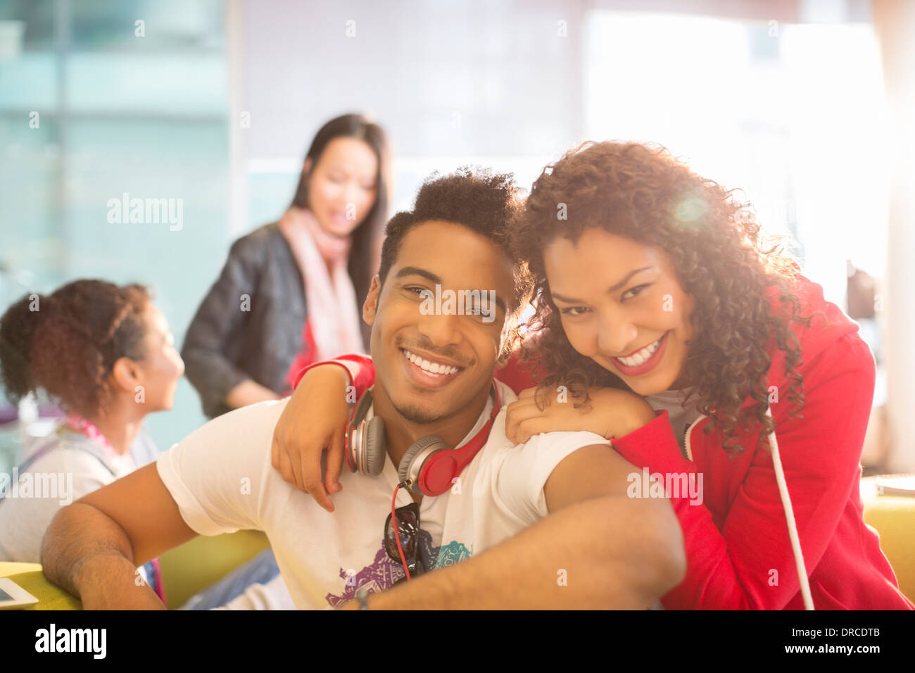 Young couple smiling in student lounge Stock Photo