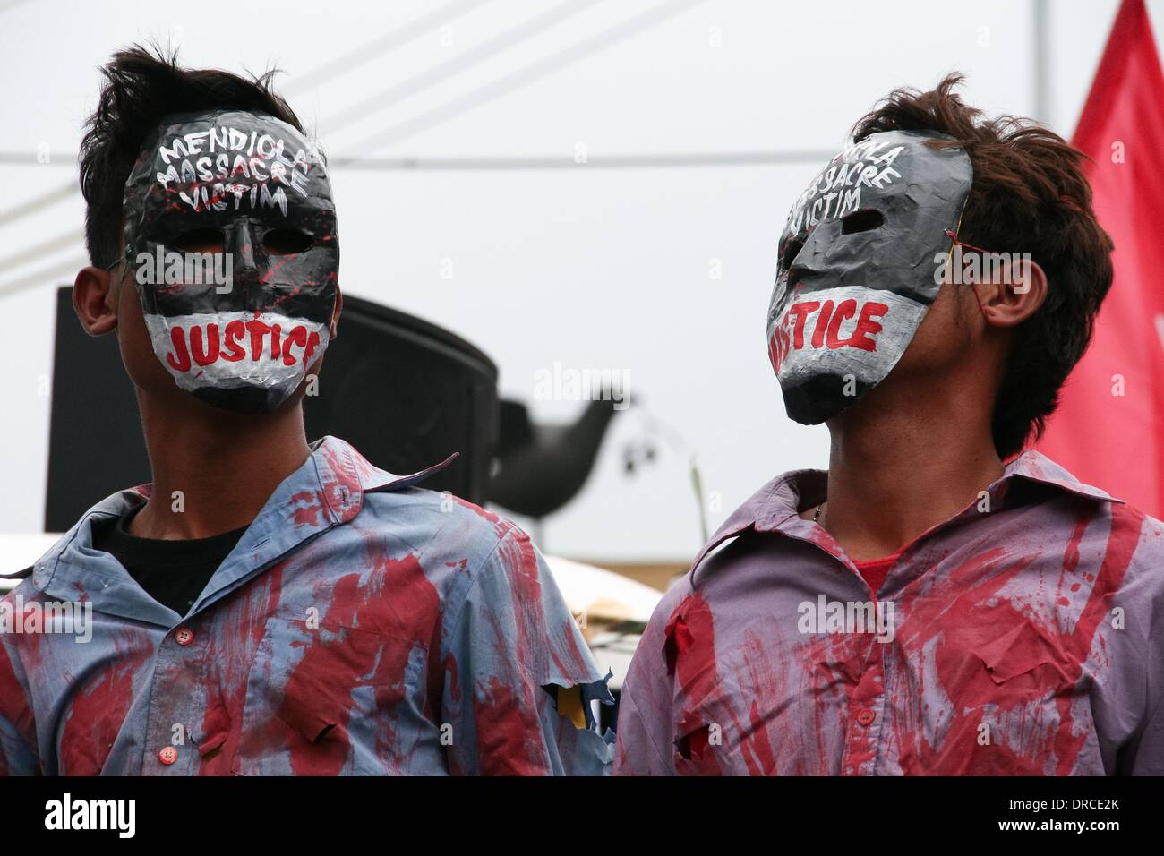 Manila, Philippines. 22nd Jan, 2014. Protesters wearing masks asking for justice for the thirteen farmers killed 27 years ago. -- Militant groups trooped to Mendiola Bridge to commemorate the 13 farmers who lost their lives after government troops opened fire at a protest rally 27 years ago. Credit:  J Gerard Seguia/NurPhoto/ZUMAPRESS.com/Alamy Live News Stock Photo