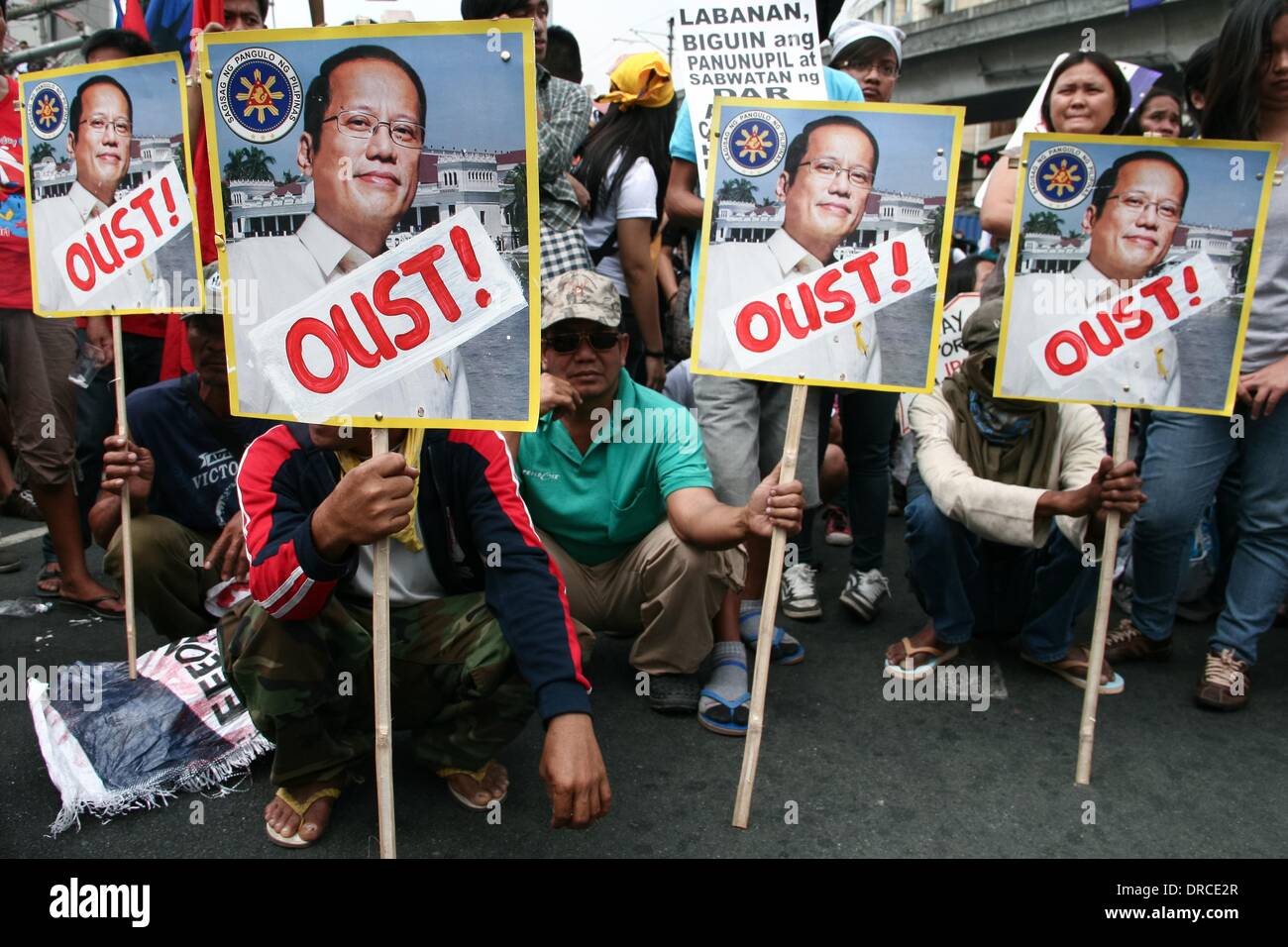 Manila, Philippines. 22nd Jan, 2014. Protesters holding placards asking to oust President Aquino. -- Militant groups trooped to Mendiola Bridge to commemorate the 13 farmers who lost their lives after government troops opened fire at a protest rally 27 years ago. Credit:  J Gerard Seguia/NurPhoto/ZUMAPRESS.com/Alamy Live News Stock Photo