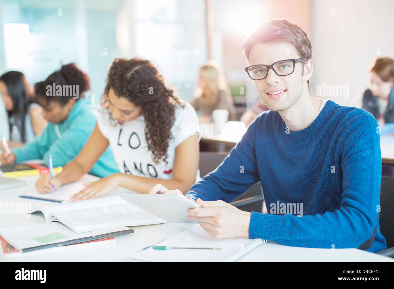 University student using digital tablet in classroom Stock Photo