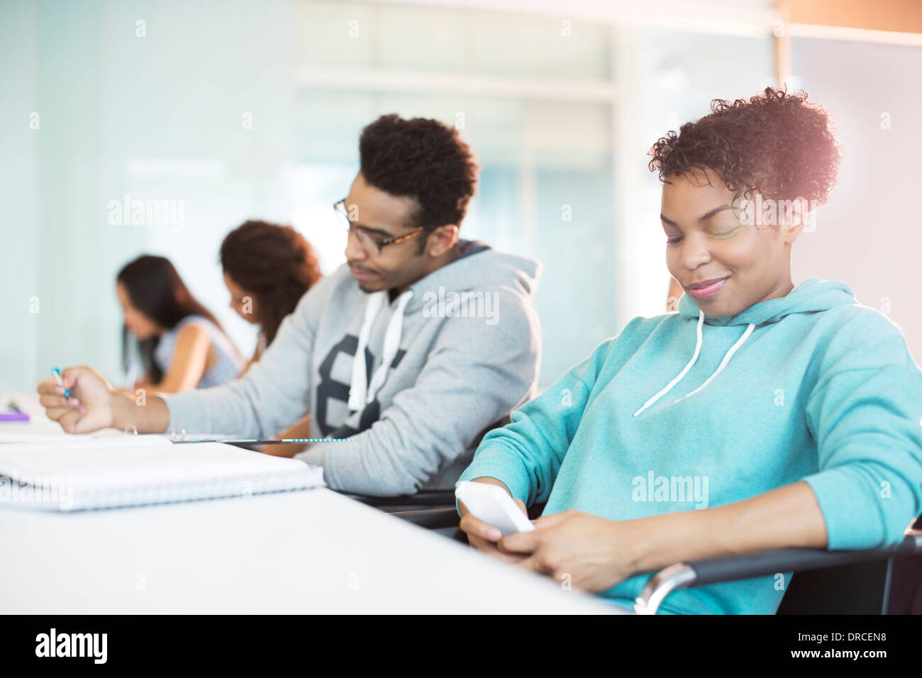 University student using cell phone in classroom Stock Photo Alamy